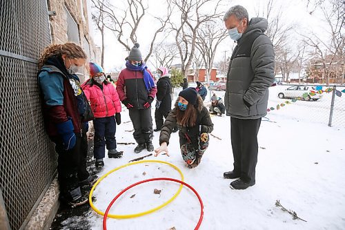 Wade Gregg, school principle, looks on as Laura Secord School teacher Ellen Lamont holds an outdoor science class at the school in Winnipeg Wednesday, January 20, 2021. Lamont has been taking her early years students outside as much as possible this year, as she embraces the benefits of outdoor education while choosing a safer mid-pandemic teaching alternative to a indoor classroom. Lamont and her class have built a snow classroom outside the Wolseley school. 

Reporter: Macintosh