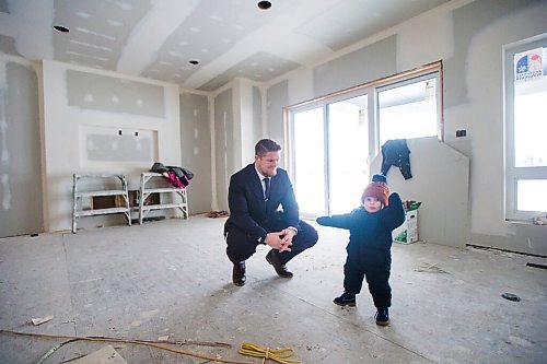 MIKAELA MACKENZIE / WINNIPEG FREE PRESS

Bombers linebacker Adam Bighill and his kid, Beau (one), check out the new home they're building in Bridgwater in Winnipeg on Friday, Jan. 22, 2021. For Jason Bell story.

Winnipeg Free Press 2021