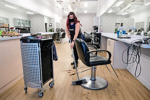 Daniel Crump / Winnipeg Free Press. Hairdresser Sabrina Cornwell cleans her workstation at Hairplay Salon after finishing with a client. Hair salons and barbershops are among the business now allowed to operate at 25% capacity. January 23, 2021.