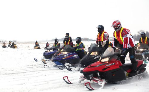 Brandon Sun 23012010 A line of snowmobilers arrive at the Brandon Municipal Airport at the end of The Journey for Sight, a snowmobile fund raising event for the Lions Eye Bank of Manitoba and Northwestern Ontario.  (Tim Smith/Brandon Sun)