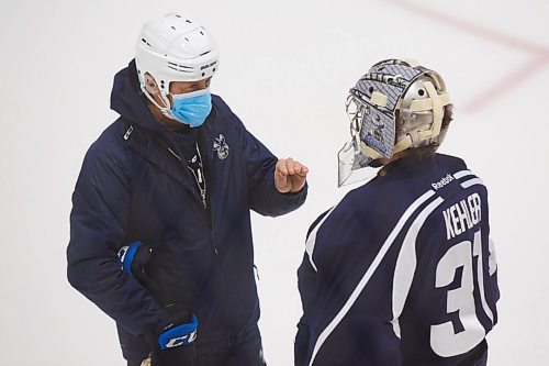 MIKE DEAL / WINNIPEG FREE PRESS
Manitoba Moose goaltender Cole Kehler (31) talks to development goaltending coach Rick St. Croix during training camp at BellMTS Iceplex Monday afternoon.
210125 - Monday, January 25, 2021.
