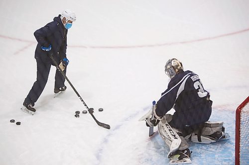MIKE DEAL / WINNIPEG FREE PRESS
Manitoba Moose goaltender Cole Kehler (31) works out with development goaltending coach Rick St. Croix during training camp at BellMTS Iceplex Monday afternoon.
210125 - Monday, January 25, 2021.