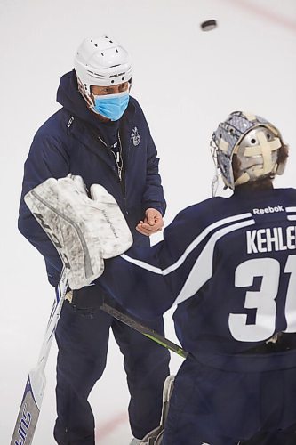 MIKE DEAL / WINNIPEG FREE PRESS
Manitoba Moose goaltender Cole Kehler (31) talks to development goaltending coach Rick St. Croix during training camp at BellMTS Iceplex Monday afternoon.
210125 - Monday, January 25, 2021.