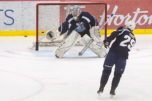 MIKE DEAL / WINNIPEG FREE PRESS
Manitoba Moose goaltender Cole Kehler (31) stretches his glove to stop a shot by Nathan Todd (29) during training camp at BellMTS Iceplex Monday afternoon.
210125 - Monday, January 25, 2021.