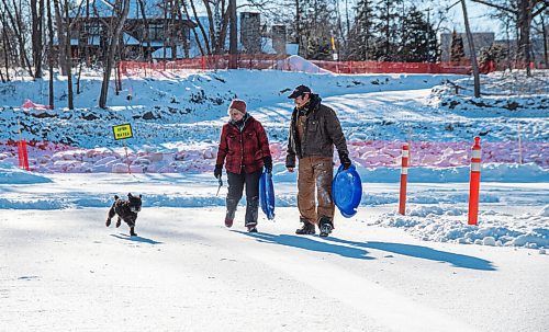 MIKE SUDOMA / WINNIPEG FREE PRESS
Rob Dorbolo, Marlies Dyck and their pup Milo share a moment after taking a slide down their home made toboggan hill Sunday morning
January 24, 2021
