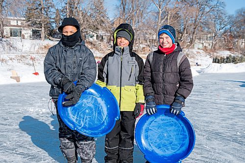 MIKE SUDOMA / WINNIPEG FREE PRESS
(Left to right) Xander Shayden, Hayden Shaw, and Evan Friedrich with heir toboggans along the Assiniboine River trail Sunday morning
January 24, 2021