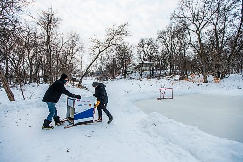 MIKAELA MACKENZIE / WINNIPEG FREE PRESS

Ron (left) and Anthony Thierault push their washing machine zamboni onto the Seine River near Marion Street in Winnipeg on Monday, Jan. 25, 2021. For JS story.

Winnipeg Free Press 2021