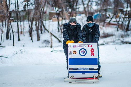 MIKAELA MACKENZIE / WINNIPEG FREE PRESS

Anthony (left) and Ron Thierault pose for a photo pushing their washing machine zamboni on the Seine River near Marion Street in Winnipeg on Monday, Jan. 25, 2021. For JS story.

Winnipeg Free Press 2021