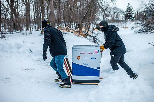 MIKAELA MACKENZIE / WINNIPEG FREE PRESS

Ron (left) and Anthony Thierault push their washing machine zamboni up off of the Seine River near Marion Street in Winnipeg on Monday, Jan. 25, 2021. For JS story.

Winnipeg Free Press 2021