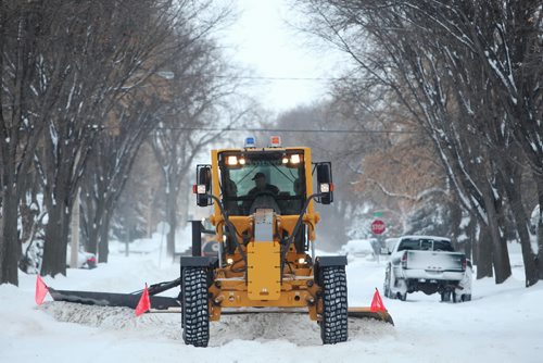 Brandon Sun 25012010 A plow clears snow from Brock Ave. in south Brandon on Monday morning after an overnight storm blanketed southern Manitoba in more snow. The snowfall combined with high winds has forced the closure of some highways throughout southern Manitoba, including Highway 1 from Portage la Prairie to Headingley. Many rural schools are also closed. (Tim Smith/Brandon Sun)