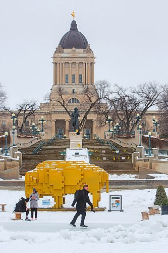 MIKE DEAL / WINNIPEG FREE PRESS
Skaters slide by the Golden Bison warming hut, which won the 2018 warming hut design competition, on the Assiniboine River at the foot of the Louis Riel statue and the Manitoba Legislative building Monday afternoon.
210201 - Monday, February 01, 2021.