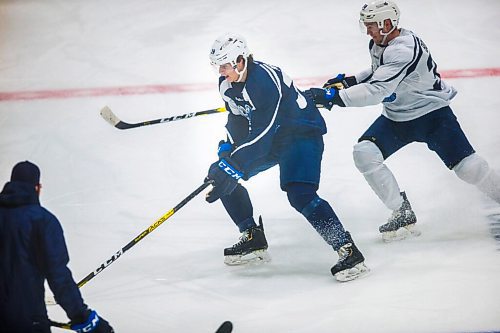 MIKAELA MACKENZIE / WINNIPEG FREE PRESS

Jeff Malott (left) and Trent Bourque go for the puck at Manitoba Moose practice at the Bell MTS Iceplex in Winnipeg on Tuesday, Feb. 2, 2021. For Mike Sawatzky story.

Winnipeg Free Press 2021