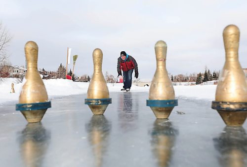 RUTH BONNEVILLE / WINNIPEG FREE PRESS 

ENT Health Column - Coronation Bowling Centre 

Jim Llewellyn, owner of Coronation Bowling Centre, throws milk jug down the ice toward pins Tuesday.  His business has been closed with restrictions so Jim built an ice bowling lane in his community on the lake in Island Lakes. 

Description:
Column is about how people have pivoted when it comes to passions and hobbies during the pandemic.

See Sabrina's Health column. 

Feb 02, 2021