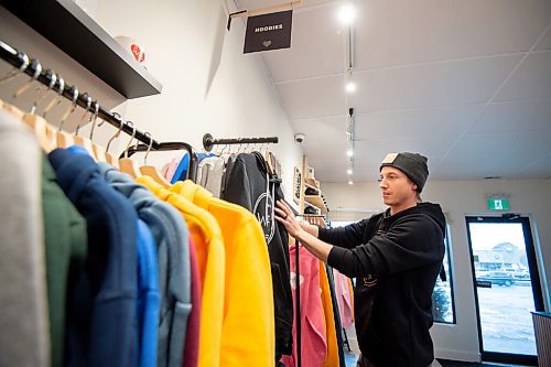 MIKE SUDOMA / WINNIPEG FREE PRESS
We Heart WPG owner, Ryan Bowman, adjusts a rack of clothing inside his newly opened shop on Osbourne St Wednesday afternoon
February 3, 2021