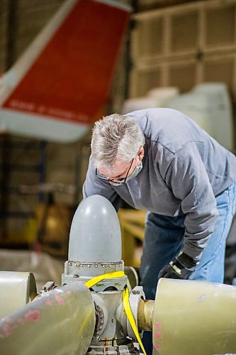 MIKAELA MACKENZIE / WINNIPEG FREE PRESS

Matt Halpin works on restoring propeller at the warehouse where exhibits are being conserved, restored, and prepared for the Western Canadian Aviation Museum (which is slated to open at the old airport in 2022) in Winnipeg on Wednesday, Feb. 3, 2021. Photo page.

Winnipeg Free Press 2021