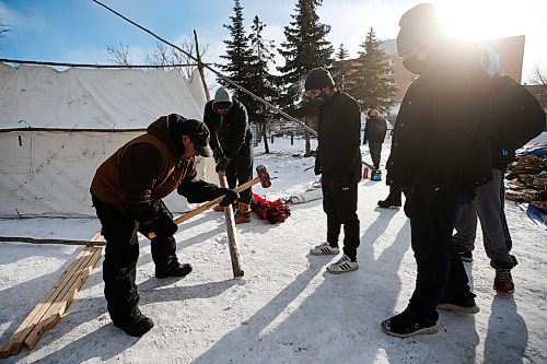 JOHN WOODS / WINNIPEG FREE PRESS
Riley Nepinak, coordinator of Anishinative, centre, and volunteers put up warming tents and teepees at Thunderbird House in Winnipeg Tuesday, February 9, 2021. 

Reporter: Abas