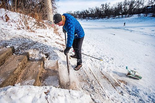 MIKAELA MACKENZIE / WINNIPEG FREE PRESS

Michael Bennett, who's organizing a fundraiser to get people to shovel and maintain river access points in Wolseley, chips the snow off the steps at the Aubrey access point to the river trail in Winnipeg on Friday, Feb. 12, 2021. For Katie story.

Winnipeg Free Press 2021