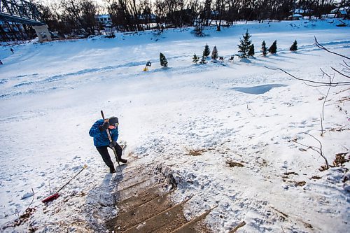 MIKAELA MACKENZIE / WINNIPEG FREE PRESS

Michael Bennett, who's organizing a fundraiser to get people to shovel and maintain river access points in Wolseley, chips the snow off the steps at the Aubrey access point to the river trail in Winnipeg on Friday, Feb. 12, 2021. For Katie story.

Winnipeg Free Press 2021