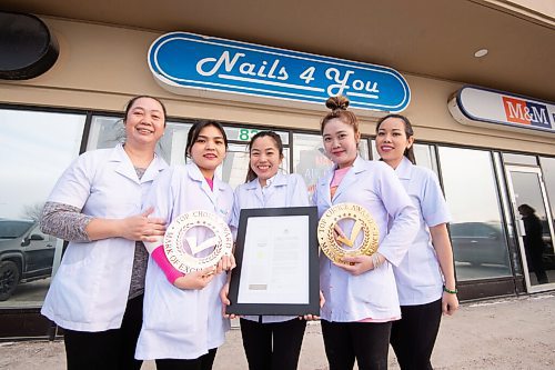 MIKE SUDOMA / WINNIPEG FREE PRESS 
Nails 4 You owner, Hoa Nguyen with staff members, (left to right) Vi Pham, Tien Duong, Tuyen Nguyen and Linh Tran hold up their 2020/2021 Top Choice Awards outside of their Salon Friday.
FEBRUARY 12, 2021