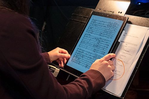 Daniel Crump / Winnipeg Free Press. Naomi Woo, an assistant conductor for the Winnipeg Symphony Orchestra, works behind-the-scenes cuing the film camera operators for the livestream shows. She uses a tablet to follow along with the music. February 13, 2021.