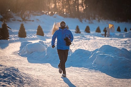 Daniel Crump / Winnipeg Free Press. A person braving frigid temperatures jogs on the Assiniboine river trail near the Forks late Saturday afternoon. February 13, 2021.