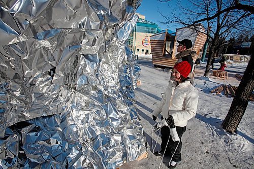 BORIS.MINKEVICH@FREEPRESS.MB.CA BORIS MINKEVICH / WINNIPEG FREE PRESS  100131 Tannis Broda and Josh Braaksma look at the warm up hut called Apparition.