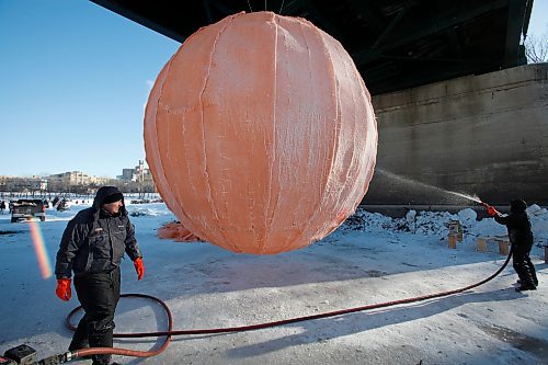 BORIS.MINKEVICH@FREEPRESS.MB.CA BORIS MINKEVICH / WINNIPEG FREE PRESS  100131 Some men work on the very unusual warm up hut art at the Forks.