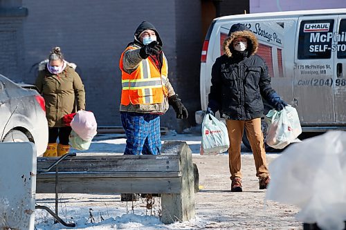 JOHN WOODS / WINNIPEG FREE PRESS
Volunteer Ray, centre, directs a person to the clothing drop-off at the Anishinative camp at Thunderbird House in Winnipeg Sunday, February 14, 2021.

Reporter: Sellar