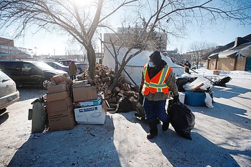 JOHN WOODS / WINNIPEG FREE PRESS
Volunteer Ray moves garbage at the Anishinative camp at Thunderbird House in Winnipeg Sunday, February 14, 2021.

Reporter: Sellar