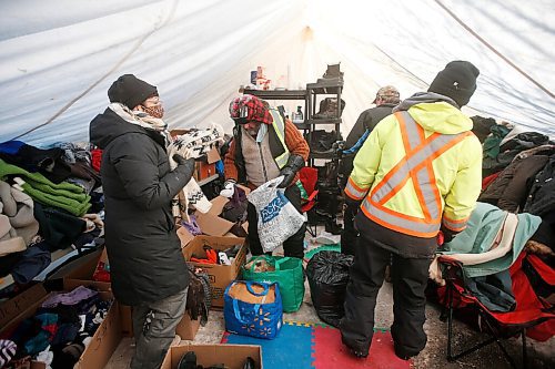 JOHN WOODS / WINNIPEG FREE PRESS
Volunteer Eva Wilson-Fontaine, left, sorts donations at the clothing drop-off at the Anishinative camp at Thunderbird House in Winnipeg Sunday, February 14, 2021.

Reporter: Sellar