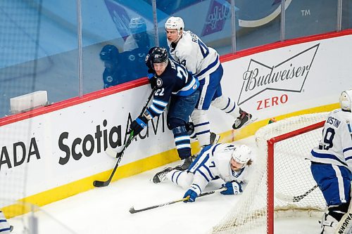 Daniel Crump / Winnipeg Free Press. Manitobas Joona Luoto (22) battles for the puck behind the Marlies goal. Manitoba Moose vs. Toronto Marlies at Bell MTS Centre, Winnipeg. February 15, 2021.