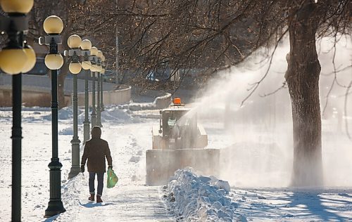 MIKE DEAL / WINNIPEG FREE PRESS
A pedestrian walks towards a snowblower making a wider path on the grounds the Manitoba Legislative building Tuesday afternoon. 
210216 - Tuesday, February 16, 2021.