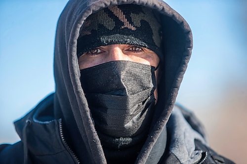 MIKAELA MACKENZIE / WINNIPEG FREE PRESS

Harrison Powder, anti-poverty advocate, poses for a portrait as police investigate the scene of a fatal fire at an encampment at 50 Higgins Avenue in Winnipeg on Tuesday, Feb. 16, 2021. For Katie story.

Winnipeg Free Press 2021