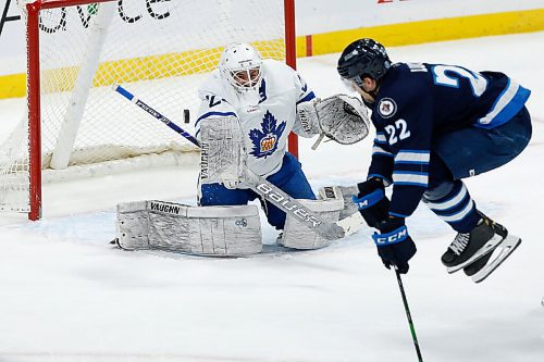 JOHN WOODS / WINNIPEG FREE PRESS
Manitoba Moose Joona Luoto (22) leaps out of the way of the point shat at Toronto Marlies goaltender Andrew D'Agostini (29) during first period AHL action in Winnipeg on Sunday, February 16, 2021.

Reporter: McIntyre