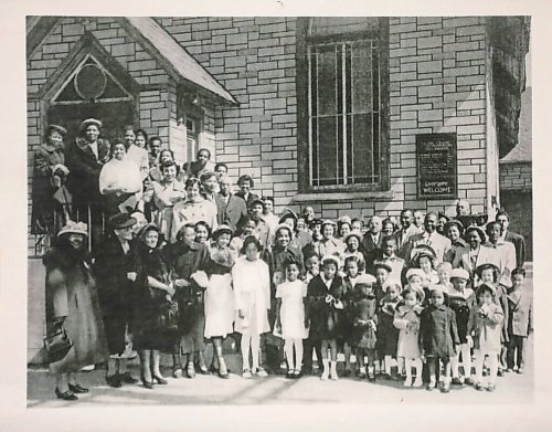 RUTH BONNEVILLE / WINNIPEG FREE PRESS 

49.8 - Pilgrim Baptist Church 

Church congregants on steps outside.

Description: Photos inside and outside the church and copied photos of exhibit of old photos on walls in the basement. 

Historical Info:  the Church which was the city's first Black church.

Reverend Dr. Joseph T. Hill was an American preacher who spent a great deal of time in Winnipeg during the 1920s and 1940s. He is also credited with founding the city's first Black church.

Pilgrim Baptist became a cornerstone of Black life in Manitoba. Aside from church services, it was a performing venue for local and visiting Black singers and celebrated American Thanksgiving annually for the large African-American contingent of the local Black community.
41 Maple St

 Reporter, JS, is looking at Winnipeg's longest-standing Black church.

Feb 17, 2021
