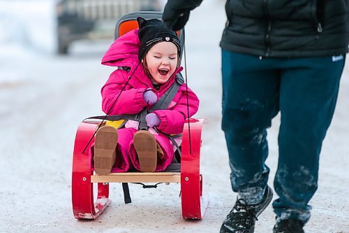 MIKAELA MACKENZIE / WINNIPEG FREE PRESS

Kyrie Brinkman gets pulled by her older brother, Everett, in her sled in Winnipeg on Thursday, Feb. 18, 2021. Four-year-old Kyrie volunteers her time as the ambassador for the Children's Rehabilitation Foundation (and is sitting in a support seat provided by the foundation).  For Aaron Epp story.

Winnipeg Free Press 2021