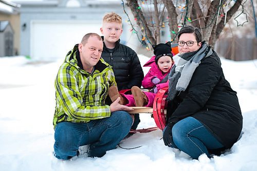 MIKAELA MACKENZIE / WINNIPEG FREE PRESS

John (left), Everett, Kyrie, and Tammy Brinkman pose for a photo in their front yard in Winnipeg on Thursday, Feb. 18, 2021. Four-year-old Kyrie volunteers her time as the ambassador for the Children's Rehabilitation Foundation (and is sitting in a support seat provided by the foundation).  For Aaron Epp story.

Winnipeg Free Press 2021