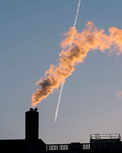 MIKE SUDOMA / WINNIPEG FREE PRESS 
A plane flies behind a puff of smoke from the former Bay store downtown Friday evening
FEBRUARY 19, 2021