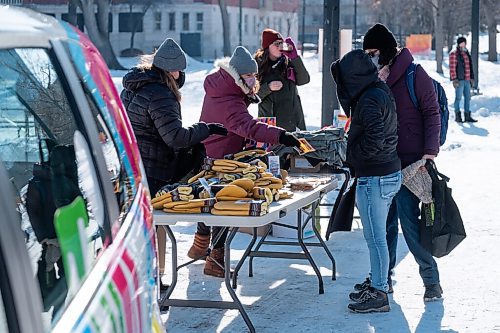 Daniel Crump / Winnipeg Free Press. Cindy Gilroy, city councillor for the Daniel Macintyre ward, and Denae Penner, director at Central Neighbourhoods, hand out gloves and toques during Heart in the Park at Central Park. February 20, 2021.