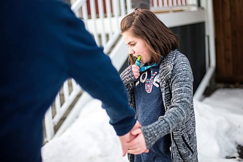 MIKAELA MACKENZIE / WINNIPEG FREE PRESS

Alejandra Felices-Costello (nine) holds her dad's hand as they get ready to pose for a portrait outside of their home in Winnipeg on Monday, Feb. 22, 2021. For Maggie Macintosh story.

Winnipeg Free Press 2021