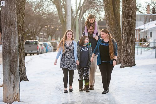 MIKAELA MACKENZIE / WINNIPEG FREE PRESS

Emma (13, left), Alejandra (nine), Isabel (six), Pablo, and  Carrie Felices-Costello pose for a portrait outside of their home in Winnipeg on Monday, Feb. 22, 2021. For Maggie Macintosh story.

Winnipeg Free Press 2021