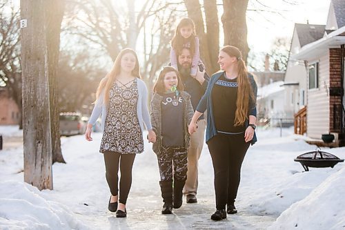 MIKAELA MACKENZIE / WINNIPEG FREE PRESS

Emma (13, left), Alejandra (nine), Isabel (six), Pablo, and  Carrie Felices-Costello pose for a portrait outside of their home in Winnipeg on Monday, Feb. 22, 2021. For Maggie Macintosh story.

Winnipeg Free Press 2021