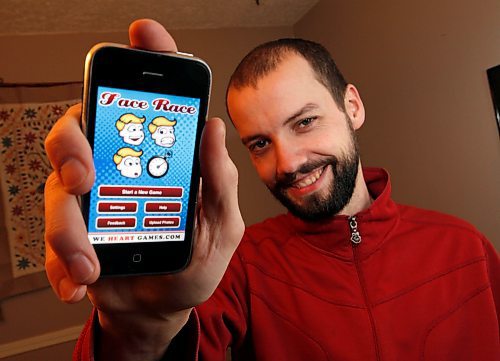 BORIS.MINKEVICH@FREEPRESS.MB.CA BORIS MINKEVICH / WINNIPEG FREE PRESS  100204 Mike Berg is an app developer for iPhones and now iPad devices. Here he poses with an iPhone app that his company developed.