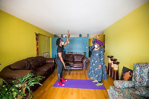 MIKAELA MACKENZIE / WINNIPEG FREE PRESS

Mwaka Kaonga and her mom, Phillis Nachilongo, demonstrate the workout that Phillis has been doing since last year at the start of the lockdown at their home in Winnipeg on Wednesday, Feb. 24, 2021. For Sabrina Carnevale story.

Winnipeg Free Press 2021