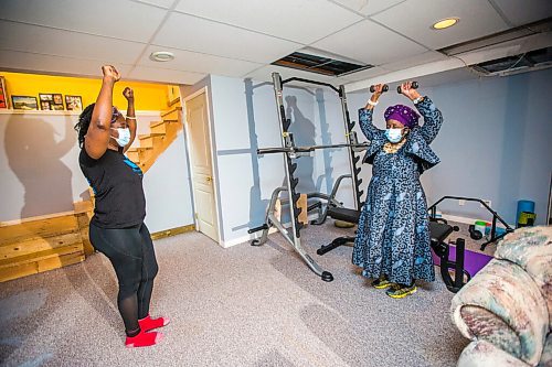 MIKAELA MACKENZIE / WINNIPEG FREE PRESS

Mwaka Kaonga and her mom, Phillis Nachilongo, demonstrate the workout that Phillis has been doing since last year at the start of the lockdown at their home in Winnipeg on Wednesday, Feb. 24, 2021. For Sabrina Carnevale story.

Winnipeg Free Press 2021