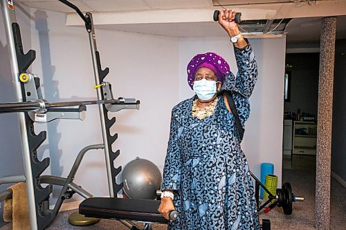 MIKAELA MACKENZIE / WINNIPEG FREE PRESS

Phillis Nachilongo demonstrates the workout that she's been doing since last year at the start of the lockdown at her home in Winnipeg on Wednesday, Feb. 24, 2021. For Sabrina Carnevale story.

Winnipeg Free Press 2021