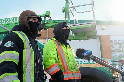 MIKE SUDOMA / WINNIPEG FREE PRESS
(Left to Right) SRS Sign employees, Sergii Koviazn and Vlad Lebedev, talk to media Thursday after using their bucket truck to save a civilian who was hanging they saw hanging from the Disraeli Overpass Wednesday afternoon
February 25, 2021