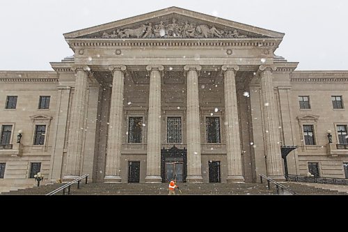 MIKE DEAL / WINNIPEG FREE PRESS
Augusto Miglioranci  a grounds keeper at the Manitoba Legislative building shovels the steps as the snow fall picks up mid-afternoon on Friday.
210226 - Friday, February 26, 2021.