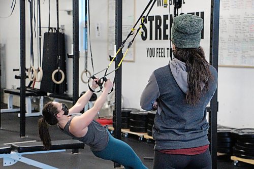 Canstar Community News Kristy Friesen works out at Harvest Health & Fitness on Feb. 25 while trainer Lisa Lewko watches on. Lewko has used her gym for personal training sessions since re-opening earlier in the month. (GABRIELLE PICHÉ/CANSTAR COMMUNITY NEWS/HEADLINER)