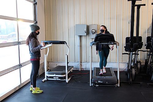 Canstar Community News Lisa Lewko, left, talks to client Kristy Friesen during Friesen's workout at Harvest Health & Fitness on Feb. 25. Lewko has been using her gym for personal training sessions since re-opening. (GABRIELLE PICHÉ/CANSTAR COMMUNITY NEWS/HEADLINER)
